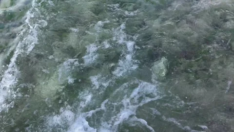 Calm waves on base beach and rocks Stock Footage 295579529