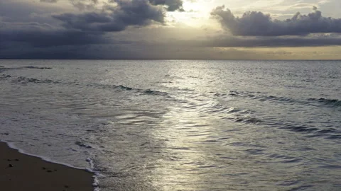 Calm waves on a beach during sunset Stock Footage 267045849