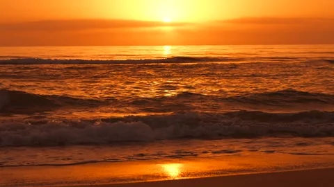 Calm waves at the beach at golden down . The sun above the horizon and calm Stock Footage 243272583