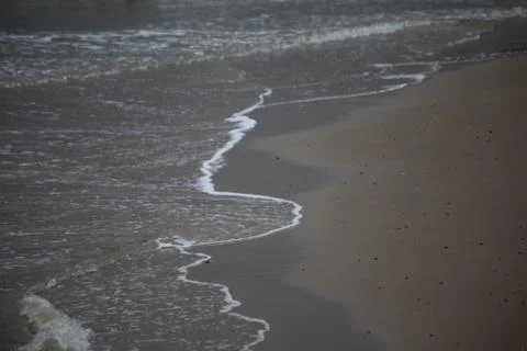 Calm waves on beach Фото