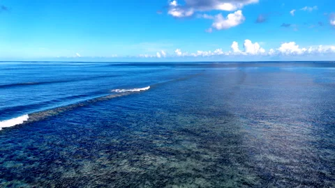 Calm waves breaking over tropical coral reef near a paradise shoreline Vídeo Stock 327387103