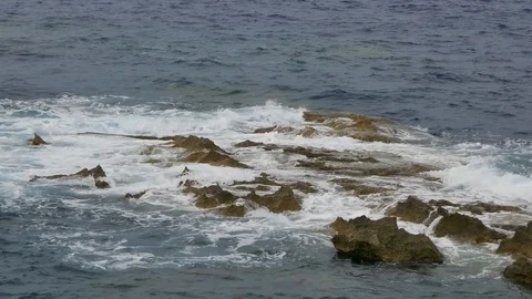 Calm waves covering cliffs inside the sea Stock Footage 108391535