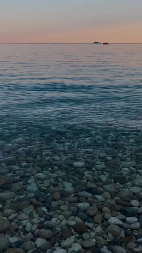 Calm waves lapping at a beach on the French Mediterranean coast,at sunrise. Stock Footage 345502705