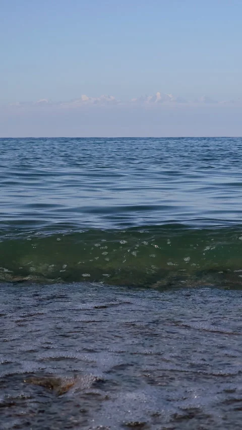 Calm waves lapping on pebbled shoreline at Issyk-Kul Lake Stockbeeldmateriaal 331359434