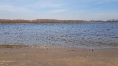 Calm waves of a river near the sandy shore Stock-Footage 108389938