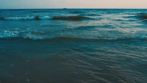 Calm waves roll over the sandy shore. Sunset at sea or ocean. Water movement Stock Footage 252492598