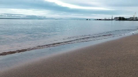 Calm waves roll on the sandy beach. Stock Footage 80355760