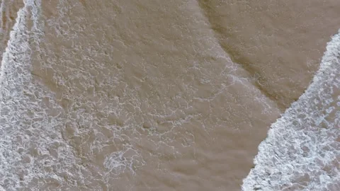 Calm waves roll onto sandy shore Stock Footage 346261780