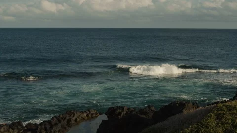 Calm waves rolling over the lava field Stock Footage 247071982