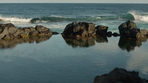 Calm waves rolling over the lava field Stock Footage 247072549