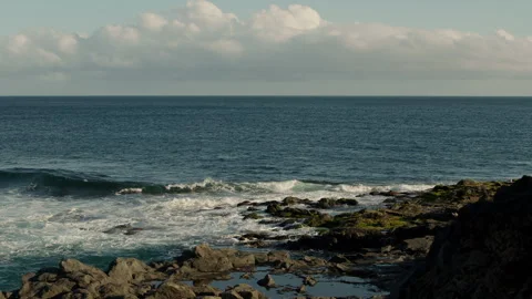 Calm waves rolling over the lava field Stock Footage 247074412