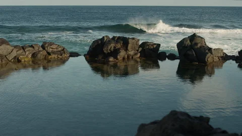 Calm waves rolling over the lava field Stock Footage 247074649