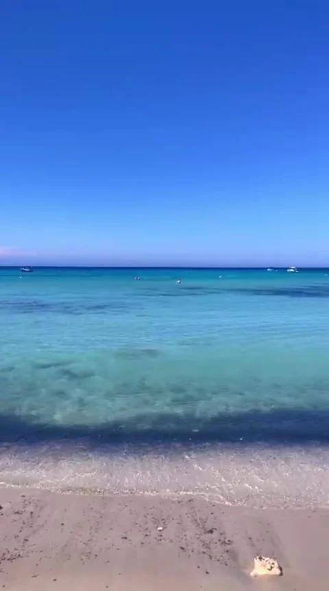 Calm Waves on Sandy Beach in Cyprus Under Blue Sky 4K Vertical Video 스톡 동영상 335925603