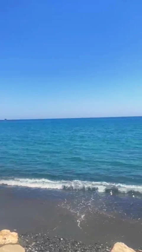 Calm Waves on Sandy Beach in Cyprus Under Blue Sky 4K Vertical Video 스톡 동영상 335932584