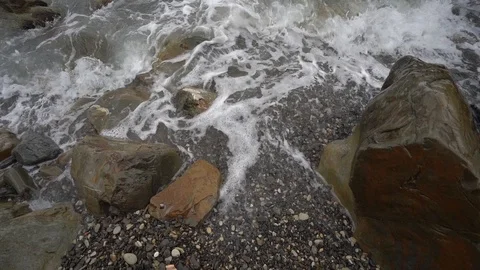 Calm waves of the sea and a stone coast with pebbles, closeup. Stock Footage 122812177