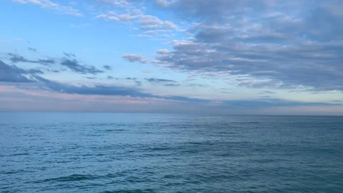 Calm waves of the sea or ocean at sunset time with beautiful cloudy sky. Stock Footage 131266612