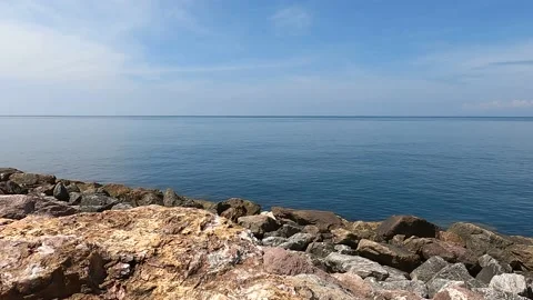Calm waves of the sea or ocean at sunset time with beautiful cloudy sky. Stock Footage 164672434