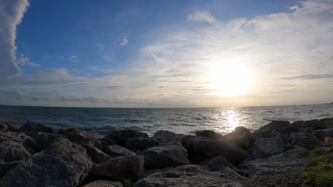 Calm waves of the sea or ocean at sunset time with beautiful cloudy sky. Stock Footage 279404630