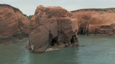 Calm Waves Splashing On The Sea Stack Near The Beach On The Magdalen Stock Footage 139277599