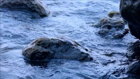 Calm waves washing rocks Stock Footage 77862835