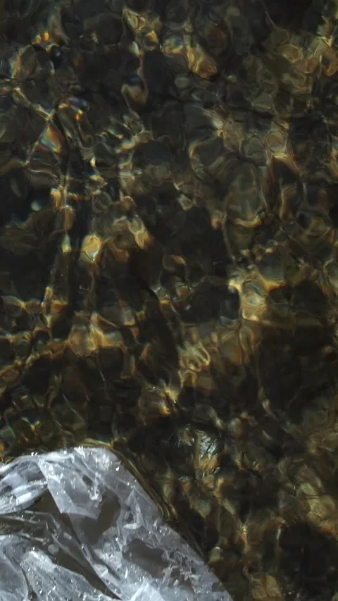 Calm waves on the water surface in the city fountain and the glare of sun light Stock Footage 248531049