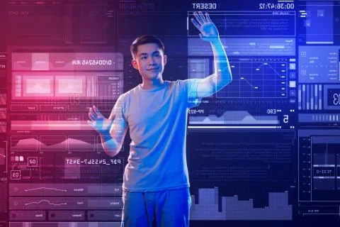 Calm web developer smiling while working with a futuristic computer Foto stock