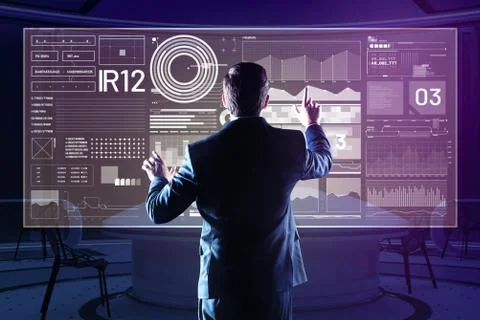 Calm web developer touching the futuristic screen while comparing diagrams Stock Photos