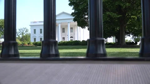 Calm White House yard with lawn view through metal fence Stock Footage 327414853