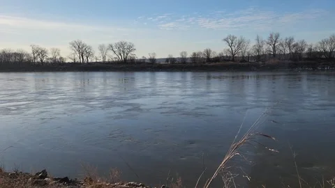 Calm winter river with gentle eddies and slow cloud movement Stock Footage 331308105