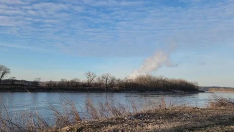 Calm Winter River with Steam Plume and Small Bird Landing on Foreground Grass Stock Footage 331316463
