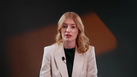 Calm woman looking at camera while second assistance camera holding clapperboard Stock Footage 263743776