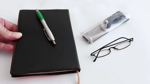 Calm Workspace: Notepad, Pen, and Glasses in Gentle Stillness Stock Footage 313043527