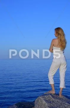 Calm young woman looking at the sea Stock Photos