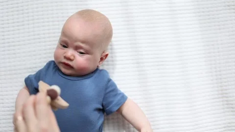 Calming down and playing with crying baby Stock Footage 152715934