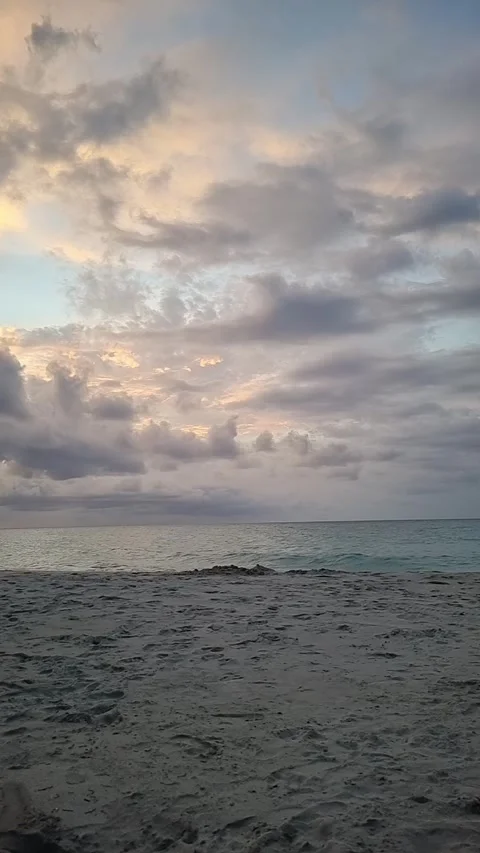 Calming ocean waves crashing on a sandy beach at sunset Stock Footage 344819118