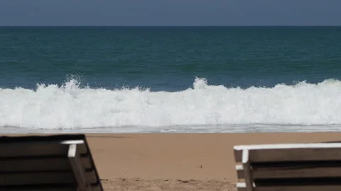 Calming ocean waves washing ashore on a sandy beach Stock-Footage 340642458