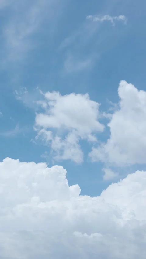 A calming vertical timelapse featuring slow-moving white clouds Stock Footage 304183599