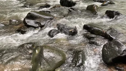 Calming water flow between rocks at Ciujung River, West Java, Indonesia Stock Footage 312395496