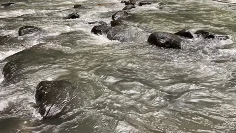 Calming water flow between rocks at Ciujung River, West Java, Indonesia Stock Footage 312399228