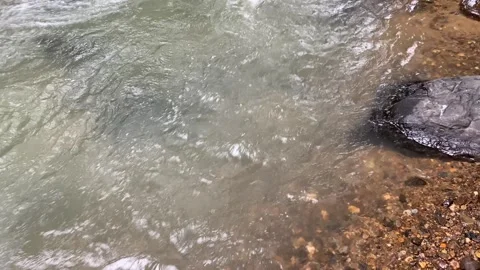 Calming water flow between rocks at Ciujung River, West Java, Indonesia Stock Footage 312399277