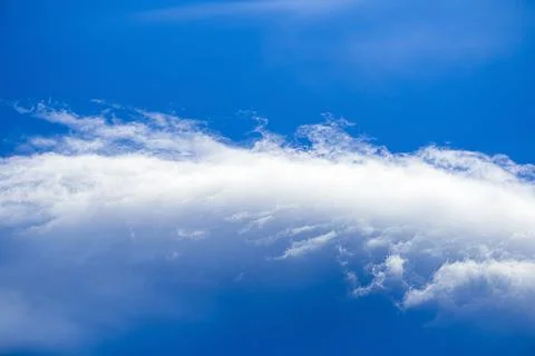 Calmly dramatic clouds in the blue sky. Heaven. Copy space Stock Photos