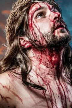 Calvary jesus, man bleeding, representation of passion with blue light halo Stock Photos