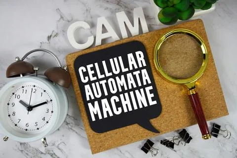 CAM Cellular Automata Machine text with alarm clock and magnifying glass on.. Stock Photos