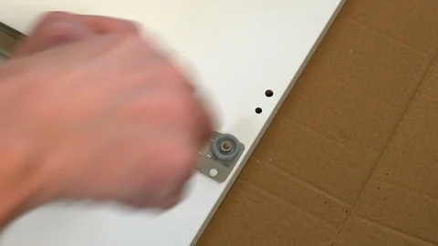 Cam Lock Screw is screwed in using a screwdriver Stock Footage 98661256