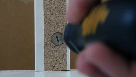 Cam lock is screwed in on flat pack furniture Stock Footage 98662201