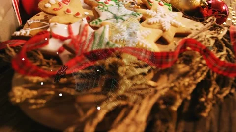 Cam pulling back tilting, showing cookies while snow drifting, evoking cozy Video stock 339448587