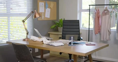 Cam is sliding forward and right, revealing wooden desk near window with laptop Stock Footage 340654346
