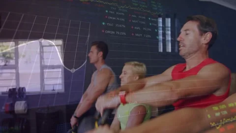 Cam zooming, four exercisers starting swinging kettlebells as data overlays Stock Footage 321782884