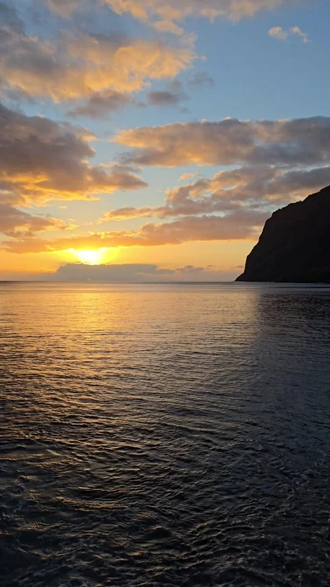 Câmara de Lobos glowing under a vivid Atlantic sunset.  Stock Footage 310024845
