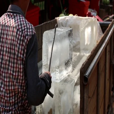 Cambodia man transporting ice block with a hook Stock Footage 69511718